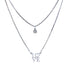 Two delicate silver necklaces on a white background. The top features a small round crystal pendant, while the bottom displays the Platinum Filled Love Pendant Stacked Necklace, showcasing a platinum-filled "LOVE" pendant with the heart replacing "O." Both are lead and nickel-free for safe and stylish wear.
